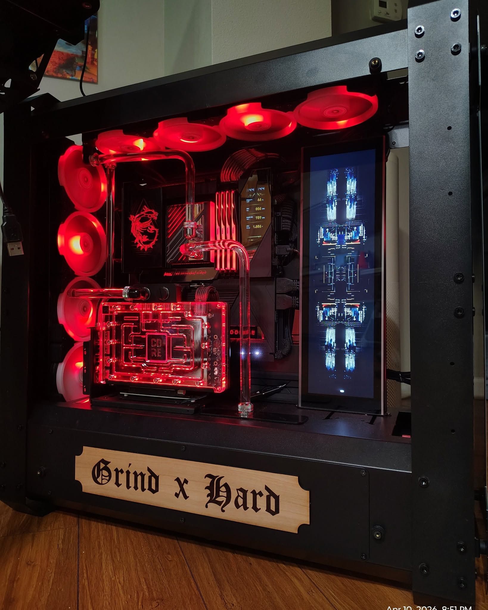 Custom liquid-cooled desktop PC with red lighting and internal display panels